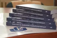 książka na tle logo UG